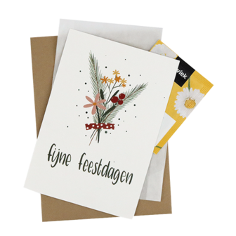 Bedankje bloemzaden met de kaart &#039;Fijne feestdagen&#039; verpakt in het pergamijnen zakje.