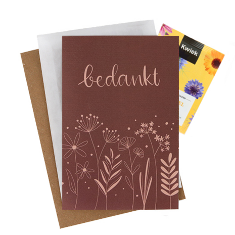 Bloemenzaden met kaart 'Bedankt' verpakt in pergamijn zakje