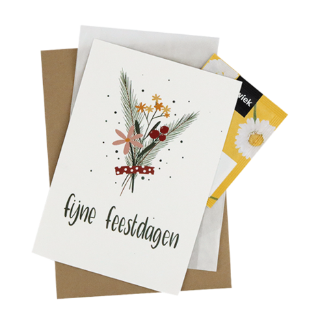 Bedankje bloemzaden met de kaart 'Fijne feestdagen' verpakt in het pergamijnen zakje.